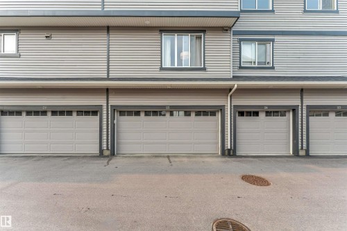 Residential building exterior featuring horizontal siding in a light gray finish - #25 1530 Tamarack Bv Nw, Edmonton, AB - Outdoor With Exterior