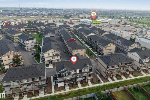 Aerial perspective showcasing a residential development with multiple townhome-style properties - #25 1530 Tamarack Bv Nw, Edmonton, AB - Outdoor With View