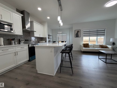 Open-concept kitchen and living area featuring wood-finish flooring - 3631 213 Street Nw, Edmonton, AB - Indoor Photo Showing Kitchen