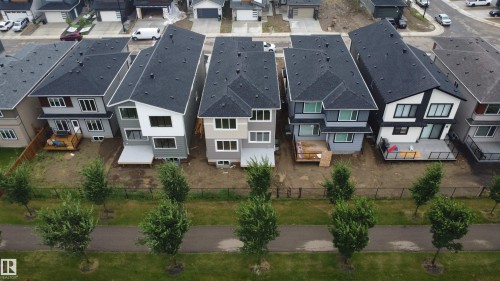 Modern residential development featuring multiple two-story homes with dark shingle roofs - 8423 Mayday Link Link Sw, Edmonton, AB - Outdoor With Facade