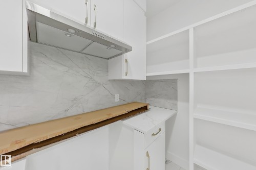 White cabinetry and integrated shelving units provide ample storage - 8423 Mayday Link Link Sw, Edmonton, AB - Indoor