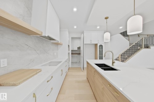 Contemporary kitchen featuring a large island with an undermount sink and a gooseneck faucet - 8423 Mayday Link Link Sw, Edmonton, AB - Indoor Photo Showing Kitchen With Double Sink With Upgraded Kitchen