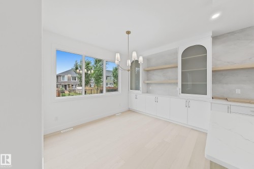 Bright dining area featuring light wood-finish flooring - 8423 Mayday Link Link Sw, Edmonton, AB - Indoor Photo Showing Other Room