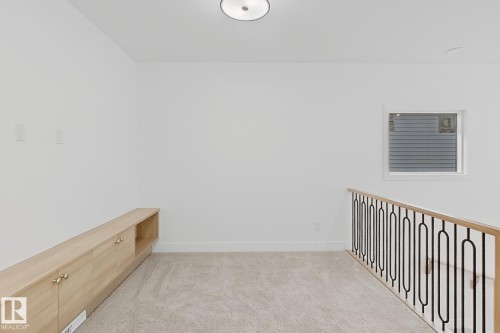 Neutral-toned carpeting complements the light-toned walls - 8423 Mayday Link Link Sw, Edmonton, AB - Indoor Photo Showing Other Room