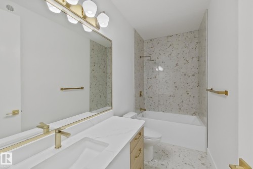 Modern bathroom featuring a single vanity with a white countertop and integrated sink - 8423 Mayday Link Link Sw, Edmonton, AB - Indoor Photo Showing Bathroom