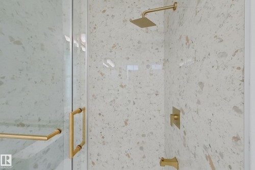Shower enclosure featuring clear glass panels, gold-tone hardware, and a rainfall showerhead - 8423 Mayday Link Link Sw, Edmonton, AB - 