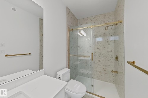 Modern bathroom with gold-finish fixtures - 8423 Mayday Link Link Sw, Edmonton, AB - Indoor Photo Showing Bathroom