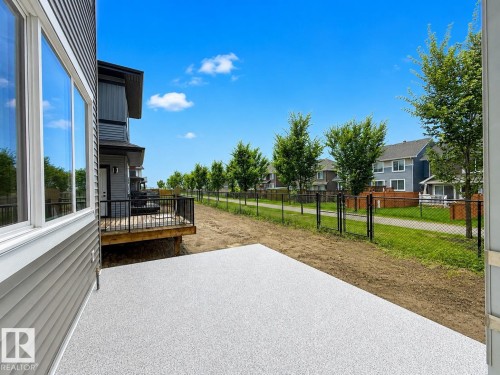 Spacious outdoor patio area featuring a modern gray speckled finish - 8423 Mayday Link Link Sw, Edmonton, AB - Outdoor
