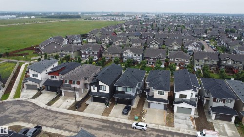 Modern residential development featuring a variety of detached homes with attached garages, paved driveways, and distinct architectural styles - 8423 Mayday Link Link Sw, Edmonton, AB - Outdoor
