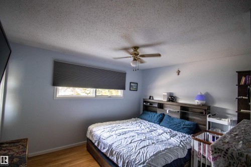 Bedroom featuring wood-finish flooring, light blue walls, and a white ceiling - 5017 55 Ave, St. Paul Town, AB - Indoor Photo Showing Bedroom