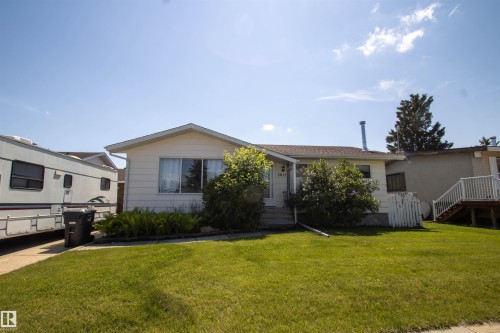 Ranch-style residence featuring light-colored siding and a brown shingle roof - 5017 55 Ave, St. Paul Town, AB - Outdoor