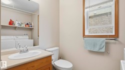 Dedicated laundry area with stacked appliances and convenient overhead shelving - 