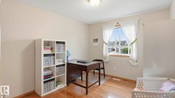 Bright room featuring wood-finish flooring, a double-hung window, and neutral wall tones - 