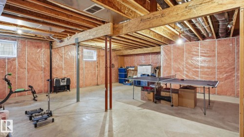 Unfinished basement offering expansive open space, concrete flooring, exposed wooden beams, and multiple windows for natural light - 125 Dechene Road Nw, Edmonton, AB - Indoor Photo Showing Basement