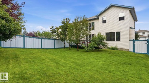 Expansive green lawn with a white privacy fence - 125 Dechene Road Nw, Edmonton, AB - Outdoor