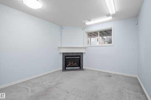 #40 1251 Rutherford Rd Sw, Edmonton, AB - Indoor Photo Showing Living Room With Fireplace