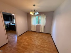 Dining area featuring wood-finish flooring and a multi-light ceiling fixture - 