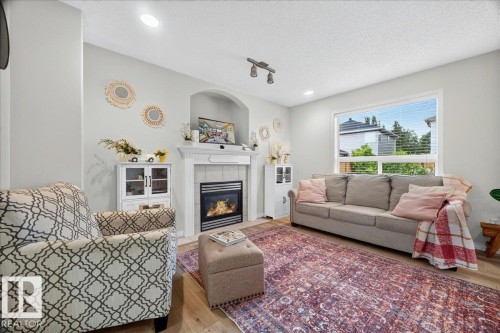 Living area featuring light wood-finish flooring and recessed lighting - 6 Norfolk Close, St. Albert, AB - Indoor Photo Showing Living Room With Fireplace