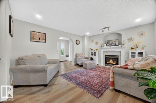 Living area featuring wood-finish flooring, recessed lighting, and a neutral color palette - 6 Norfolk Close, St. Albert, AB - Indoor Photo Showing Living Room With Fireplace