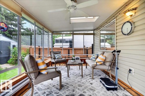 Enclosed patio featuring a ceiling fan, skylight, and wood-finish flooring - 6 Norfolk Close, St. Albert, AB - Outdoor With Exterior
