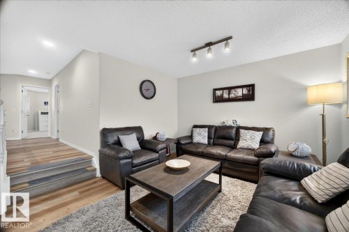 Living area featuring wood-finish flooring, light neutral wall paint, and recessed lighting - 6 Norfolk Close, St. Albert, AB - Indoor Photo Showing Living Room