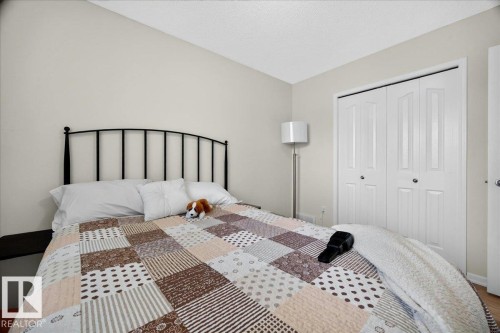 Bedroom featuring light-toned walls, a white textured ceiling, and wood-finish flooring - 6 Norfolk Close, St. Albert, AB - Indoor Photo Showing Bedroom