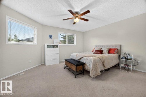 Spacious room featuring neutral carpeting, light-toned walls, and a ceiling fan with integrated lighting - 6 Norfolk Close, St. Albert, AB - Indoor Photo Showing Bedroom