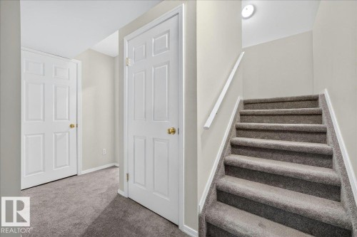 Carpeted staircase with white handrail and trim - 6 Norfolk Close, St. Albert, AB - Indoor Photo Showing Other Room
