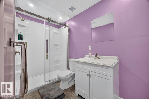 Bathroom featuring a white vanity with integrated sink, chrome faucet, and a frameless mirror - 6 Norfolk Close, St. Albert, AB - Indoor Photo Showing Bathroom