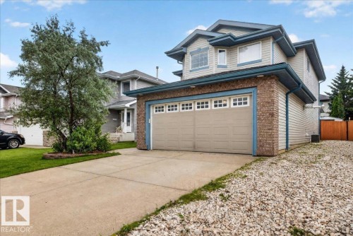 Two-story residence featuring light-colored siding and a brick-front garage - 6 Norfolk Close, St. Albert, AB - Outdoor