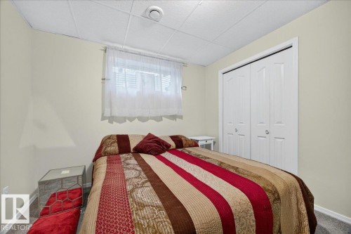 Neutral wall paint with textured drop ceiling - 6 Norfolk Close, St. Albert, AB - Indoor Photo Showing Bedroom