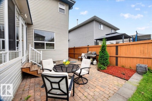 Expansive paver patio with a wood privacy fence and established landscaping - 6 Norfolk Close, St. Albert, AB - Outdoor With Deck Patio Veranda With Exterior