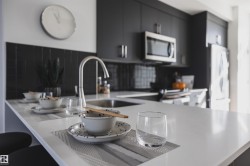 Kitchen featuring a substantial island with white countertops - 