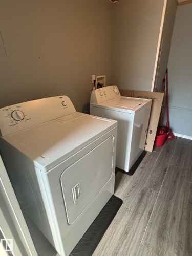 Large Laundry/storage space with new vinyl plank flooring - 20 Sunset Boulevard, Spruce Grove, AB - Indoor Photo Showing Laundry Room