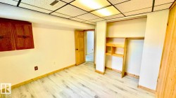 Room featuring light wood-finish flooring, white walls, and wood trim - 