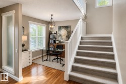 Carpeted staircase with white balusters and handrail - 