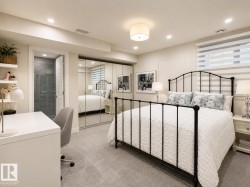 Bedroom featuring plush grey carpeting, a full wall of mirrored closet doors, recessed lighting, and a window with horizontal blinds - 