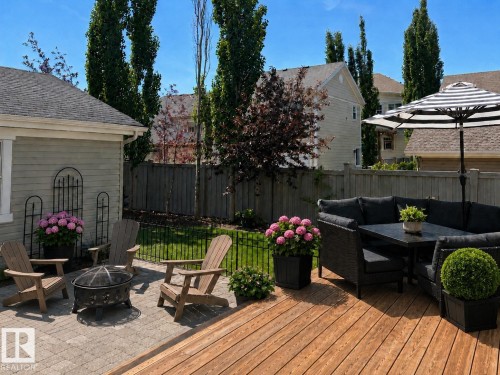 Expansive wood-finish deck with an integrated paver patio - 2337 Frezenberg Avenue Nw, Edmonton, AB - Outdoor With Deck Patio Veranda