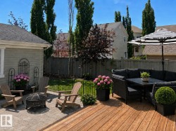 Expansive wood-finish deck with an integrated paver patio - 