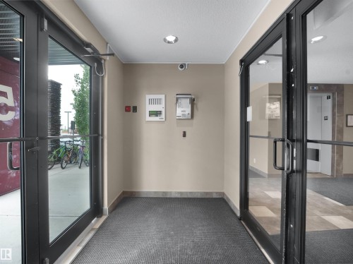 Entryway featuring black-framed glass doors, recessed lighting, and a neutral wall finish - #422 5515 7 Av Sw, Edmonton, AB - Indoor Photo Showing Other Room