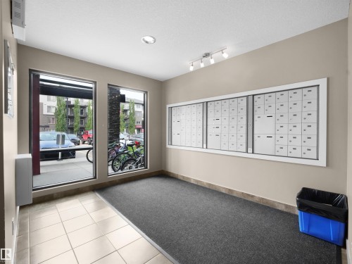 Mailroom featuring a wall-mounted mailbox system, recessed lighting, and track lighting - #422 5515 7 Av Sw, Edmonton, AB - Indoor Photo Showing Other Room
