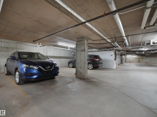 Concrete slab flooring throughout the subterranean parking garage - #422 5515 7 Av Sw, Edmonton, AB - Indoor Photo Showing Garage