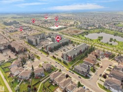Aerial view showcasing a residential neighborhood with diverse housing types, including multi-story apartment buildings and single-family homes - 