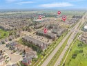 Aerial overview displaying a residential area with multi-story apartment buildings, single-family homes, and established commercial developments - #422 5515 7 Av Sw, Edmonton, AB  - Outdoor With View 