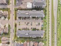 Aerial perspective showcasing two multi-story residential buildings with surface parking areas - #422 5515 7 Av Sw, Edmonton, AB  - Other 