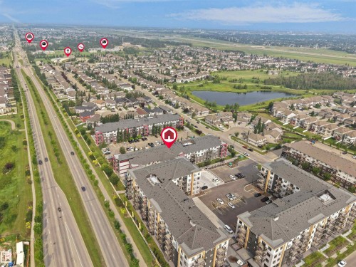 Aerial perspective showcasing apartment complexes, a residential neighborhood, and a large body of water - #422 5515 7 Av Sw, Edmonton, AB - Outdoor With View