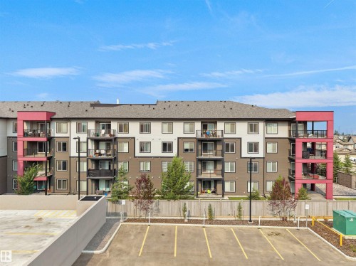 Multi-story building featuring a mixed-material facade with white, gray, and brown siding accents - #422 5515 7 Av Sw, Edmonton, AB - Outdoor With Facade