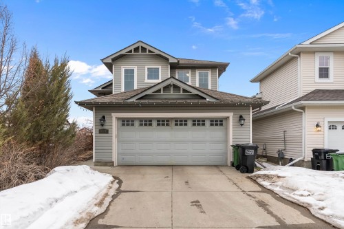 Contemporary two-story residence featuring light gray siding and a prominent attached garage - 16748 118 Street Nw, Edmonton, AB - Outdoor With Facade