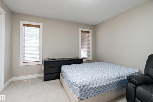 Neutral wall paint complemented by white trim and light-colored carpeting - 16748 118 Street Nw, Edmonton, AB - Indoor Photo Showing Bedroom