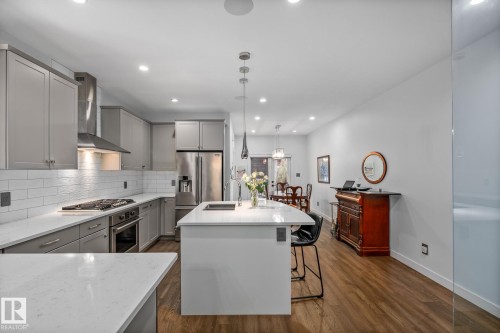 Modern kitchen with light gray cabinetry, white subway tile backsplash, and stainless steel appliances - 14221 101 Avenue Nw, Edmonton, AB - Indoor Photo Showing Kitchen With Upgraded Kitchen